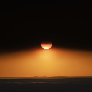 Sun dipping below the canopy of wildfire smoke at sunset