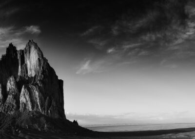 A long shadow casted by Shiprock at sunset