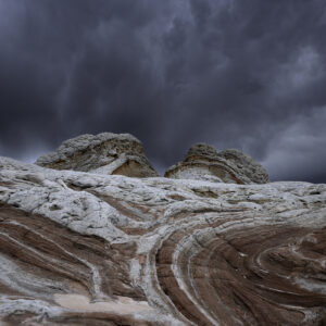 Surreal rock formations against a stormy afternoon sky