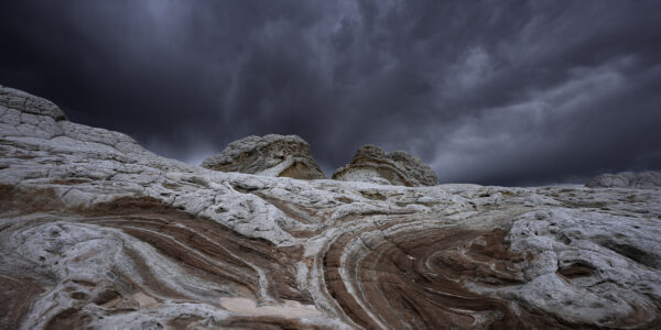 Surreal rock formations against a stormy afternoon sky