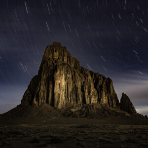 Shiprock lit up by the moon during a 20 min exposure for star trails