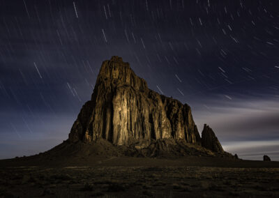 Shiprock lit up by the moon during a 20 min exposure for star trails