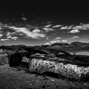 Classic car with bullet holes in the middle of the desert