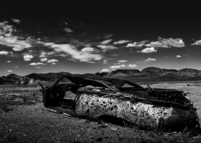 Classic car with bullet holes in the middle of the desert