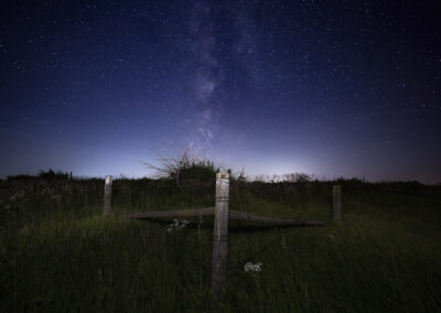 Country Fence along a dark country gravel road in Iowa under the Milky Way