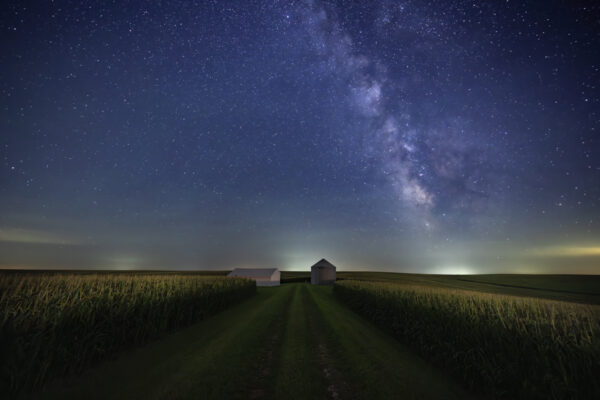 Grain bin and shed under the Milky in Iowa